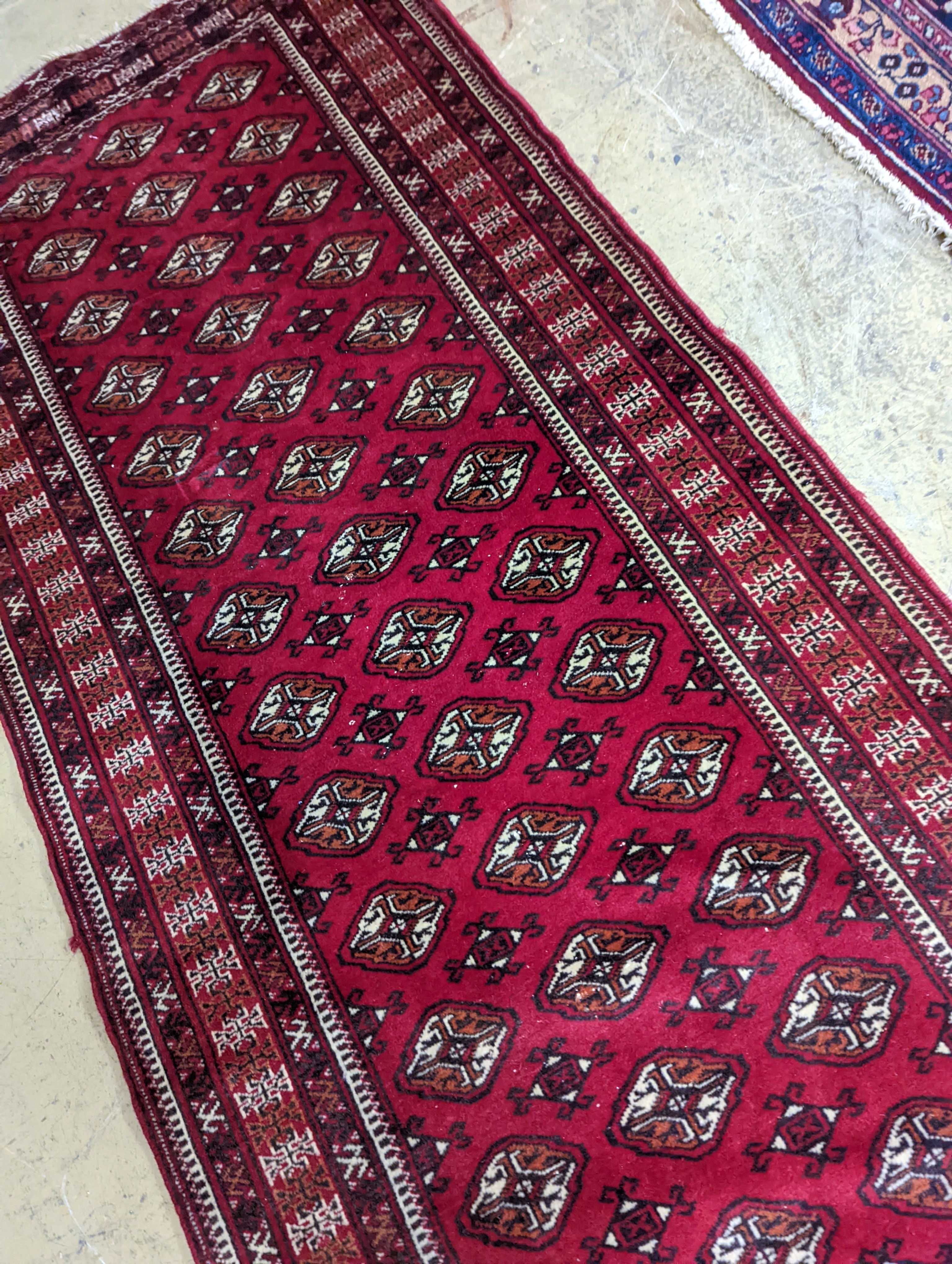 A Bokhara red ground runner, 364 x 98cm